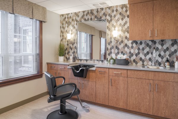 resident hair salon with barber chair and hair washing sink