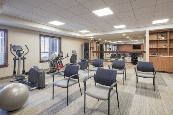 resident exercise room with chairs and cardio equipment