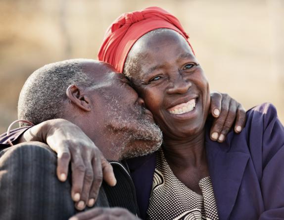 man kissing woman on cheek