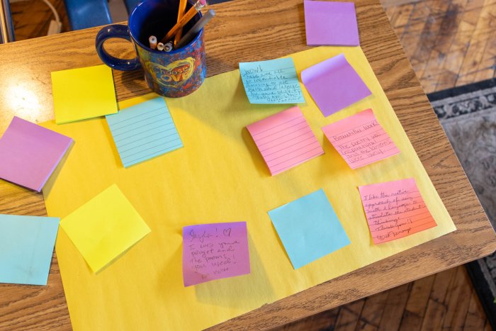 post-it notes with words of encouragement for students on a large piece of paper