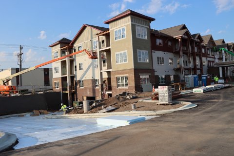 Exterior perspective of an apartment building under construction