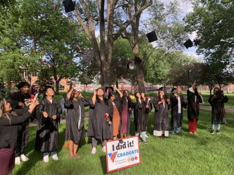 VOA High School Graduates tossing their caps in the air at a graduation ceremony