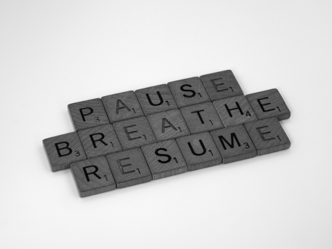 Scrabble tiles spell Pause, Breathe, Resume
