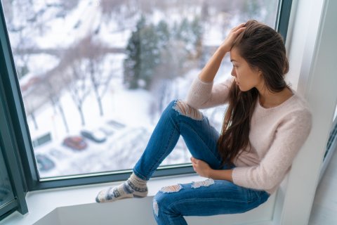 sad girl looking out window