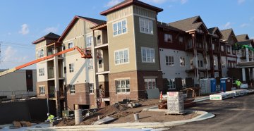 Exterior perspective of an apartment building under construction