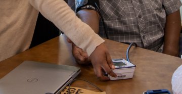 A Community Health Worker checking the blood pressure of her client