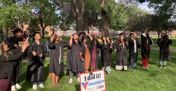 VOA High School Graduates tossing their caps in the air at a graduation ceremony