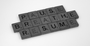 Scrabble tiles spell Pause, Breathe, Resume