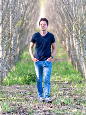Young man walking through the woods