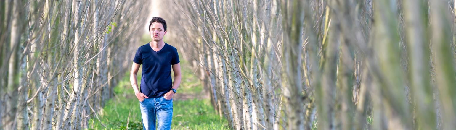 Young man walking through the woods