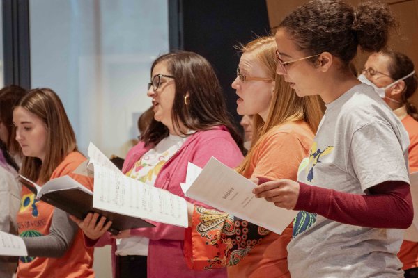 A diverse group of women singing 