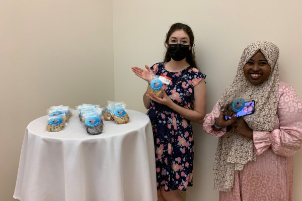 Two VOA volunteers holding up cookies
