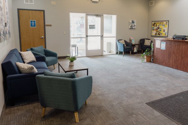 Main lobby area at Avanti with couch, two chairs and front desk - what you will see coming in as a visitor on your first day