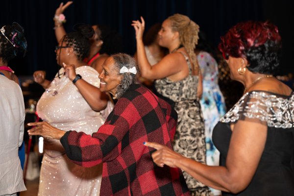 A group of older women in dresses dancing