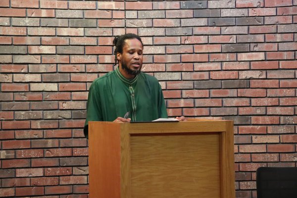 man speaking behind a podium