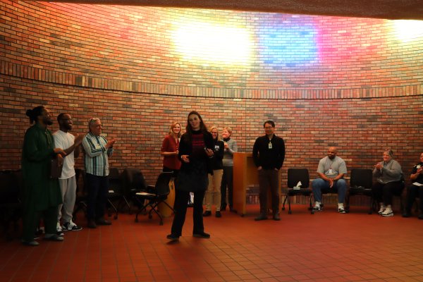 a women speaking in front of a group of people