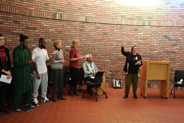 a woman speaking to a group of people